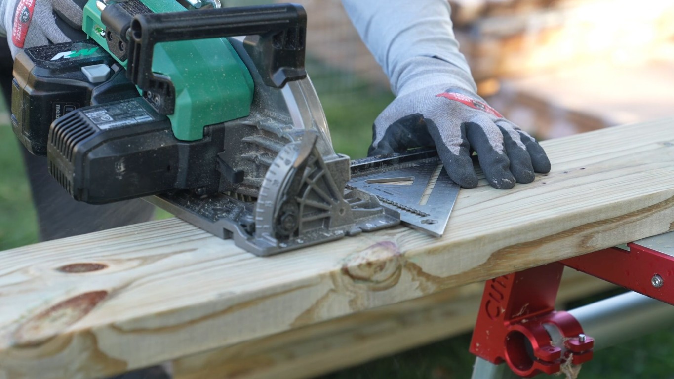 Skilled carpenter cutting precision lumber for custom deck construction in Salinas